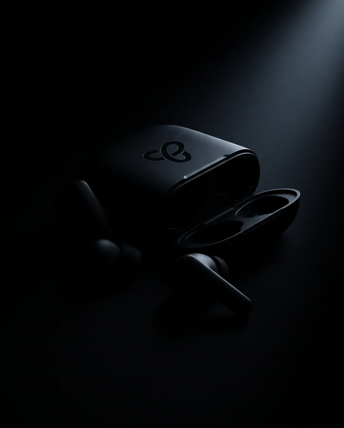 Truelink Buds and their case, almost hidden in the dark — coming soon